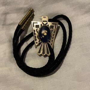 Gold Thunderbird Bolo Tie with Blue Stone